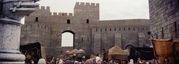 Movie still from “Ben-Hur” (1959), directed by William Wyler – A crowd of people standing around a stone wall; Extreme Wide shot, Low angle