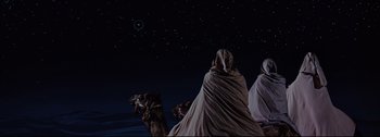 Movie still from “Ben-Hur” (1959), directed by William Wyler – A man riding a camel through the desert at night; Wide shot, Low angle