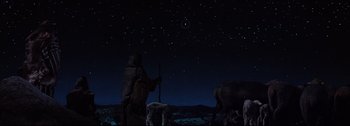 Movie still from “Ben-Hur” (1959), directed by William Wyler – A man standing in the dark under a night sky; Extreme Wide shot, Low angle
