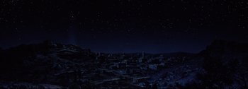 Movie still from “Ben-Hur” (1959), directed by William Wyler – A night sky filled with stars over a city; Extreme Wide shot, Low angle