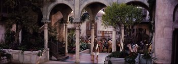 Movie still from “Ben-Hur” (1959), directed by William Wyler – A group of people standing in a courtyard with arches; Extreme Wide shot, High angle