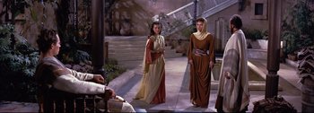 Movie still from “Ben-Hur” (1959), directed by William Wyler – Two people dressed in ancient roman clothing in front of a staircase; Wide shot, Over the shoulder angle