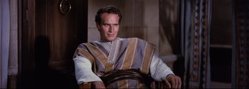 Movie still from “Ben-Hur” (1959), directed by William Wyler – A person sitting in a chair; Medium shot, High angle