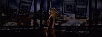 Movie still from “Ben-Hur” (1959), directed by William Wyler – A woman standing in front of a building; Wide shot, Low angle