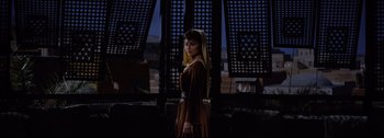 Movie still from “Ben-Hur” (1959), directed by William Wyler – A woman standing in front of a building; Wide shot, Low angle
