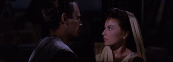 Movie still from “Ben-Hur” (1959), directed by William Wyler – A man and a woman face to face in a dark room; Close Up shot, Over the shoulder angle