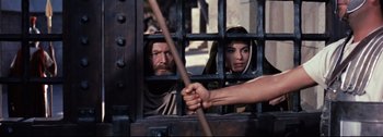 Movie still from “Ben-Hur” (1959), directed by William Wyler – A man and a woman behind bars in a jail cell; Medium shot, Over the shoulder angle