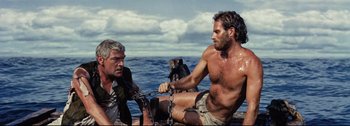 Movie still from “Ben-Hur” (1959), directed by William Wyler – Two men sitting on a boat in the water; Medium shot, Low angle
