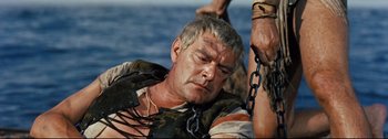 Movie still from “Ben-Hur” (1959), directed by William Wyler – An older man is chained to a boat; Close Up shot, High angle