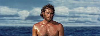 Movie still from “Ben-Hur” (1959), directed by William Wyler – A man with long hair and a beard is standing in the water; Close Up shot, Low angle