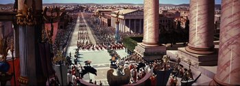 Movie still from “Ben-Hur” (1959), directed by William Wyler – A crowd of people walking on a street next to tall buildings; Extreme Wide shot, High angle