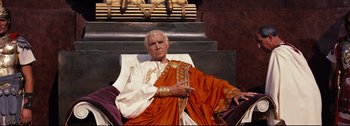 Movie still from “Ben-Hur” (1959), directed by William Wyler – An older man sitting in a chair wearing a robe; Medium shot, Low angle