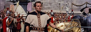 Movie still from “Ben-Hur” (1959), directed by William Wyler – A man in a roman outfit standing in front of a crowd of people; Medium shot, Low angle