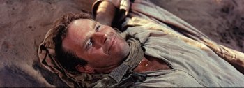 Movie still from “Ben-Hur” (1959), directed by William Wyler – A person laying on the ground; Close Up shot, Overhead angle