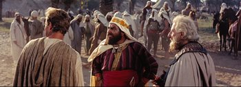 Movie still from “Ben-Hur” (1959), directed by William Wyler – Many people that are walking in the desert; Medium shot, Over the shoulder angle