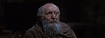 Movie still from “Ben-Hur” (1959), directed by William Wyler – An old man with a long beard wearing a blanket; Close Up shot, Low angle