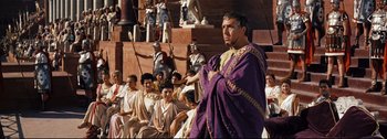Movie still from “Ben-Hur” (1959), directed by William Wyler – A man dressed in roman clothing and holding a sword; Medium shot, Over the shoulder angle