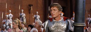 Movie still from “Ben-Hur” (1959), directed by William Wyler – A man in a roman soldier's outfit stands in front of a crowd; Close Up shot, Low angle