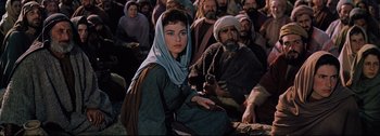 Movie still from “Ben-Hur” (1959), directed by William Wyler – A woman sitting in front of a group of people; Medium shot, High angle