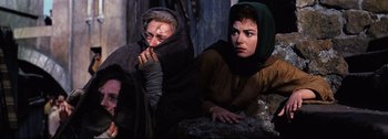 Movie still from “Ben-Hur” (1959), directed by William Wyler – Two women in medieval garb sitting next to each other; Medium shot, High angle