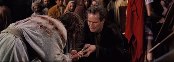 Movie still from “Ben-Hur” (1959), directed by William Wyler – A man holding a bowl with a crown of thorns on top of it; Medium shot, High angle
