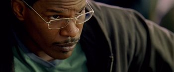 Movie still from “Collateral” (2004), directed by Michael Mann – A person wearing glasses; Close Up shot, Low angle