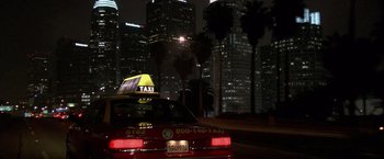 Movie still from “Collateral” (2004), directed by Michael Mann – A taxi cab driving down a street at night; Extreme Wide shot, Low angle