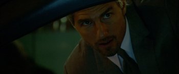 Movie still from “Collateral” (2004), directed by Michael Mann – A person wearing a suit and a hat; Close Up shot, Over the shoulder angle