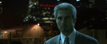 Movie still from “Collateral” (2004), directed by Michael Mann – A person wearing a suit and tie; Close Up shot, Low angle
