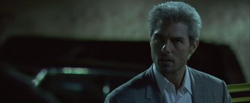 Movie still from “Collateral” (2004), directed by Michael Mann – A person wearing a suit and tie; Close Up shot, Over the shoulder angle