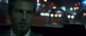 Movie still from “Collateral” (2004), directed by Michael Mann – A person wearing a suit in a car; Close Up shot, Over the shoulder angle
