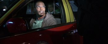 Movie still from “Collateral” (2004), directed by Michael Mann – A man sitting in the driver's seat of a car; Close Up shot, Over the shoulder angle