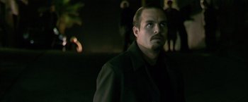 Movie still from “Collateral” (2004), directed by Michael Mann – A person wearing a black shirt; Close Up shot, Over the shoulder angle