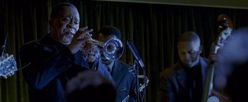 Movie still from “Collateral” (2004), directed by Michael Mann – A man playing a trumpet in front of a microphone; Close Up shot, Low angle