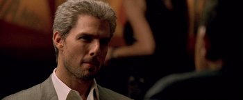 Movie still from “Collateral” (2004), directed by Michael Mann – A person wearing a suit and tie; Close Up shot, Over the shoulder angle