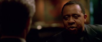 Movie still from “Collateral” (2004), directed by Michael Mann – A person sitting in a room; Close Up shot, Over the shoulder angle