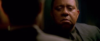 Movie still from “Collateral” (2004), directed by Michael Mann – A person looking at a mirror; Close Up shot, Over the shoulder angle