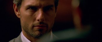 Movie still from “Collateral” (2004), directed by Michael Mann – A person wearing a suit and tie; Close Up shot, Over the shoulder angle