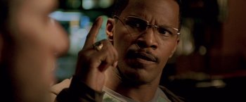 Movie still from “Collateral” (2004), directed by Michael Mann – A person holding a finger up; Close Up shot, High angle