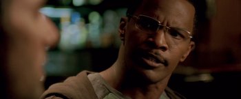 Movie still from “Collateral” (2004), directed by Michael Mann – A person wearing glasses; Close Up shot, Over the shoulder angle