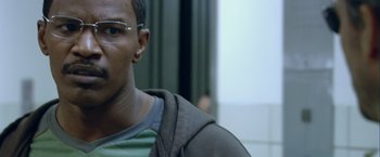Movie still from “Collateral” (2004), directed by Michael Mann – A person wearing glasses; Close Up shot, Over the shoulder angle
