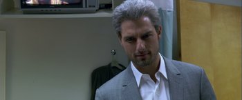 Movie still from “Collateral” (2004), directed by Michael Mann – A person wearing a suit and tie; Close Up shot, Over the shoulder angle