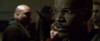 Movie still from “Collateral” (2004), directed by Michael Mann – A person wearing glasses; Close Up shot, Over the shoulder angle