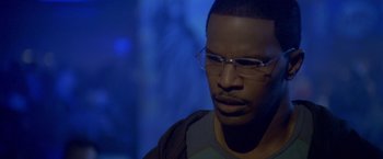 Movie still from “Collateral” (2004), directed by Michael Mann – A person wearing glasses; Close Up shot, High angle