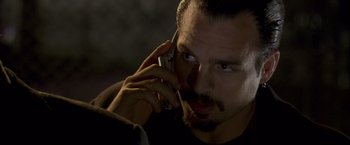 Movie still from “Collateral” (2004), directed by Michael Mann – A person talking on a cell phone; Close Up shot, Low angle