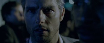 Movie still from “Collateral” (2004), directed by Michael Mann – A man's face in the dark; Close Up shot, Over the shoulder angle