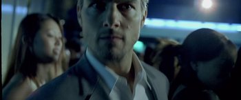 Movie still from “Collateral” (2004), directed by Michael Mann – A person wearing a suit and tie; Close Up shot, Low angle