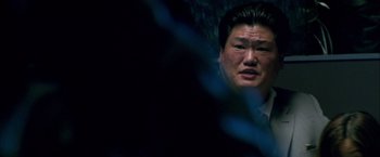 Movie still from “Collateral” (2004), directed by Michael Mann – A person in a dark room; Close Up shot, Over the shoulder angle