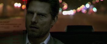 Movie still from “Collateral” (2004), directed by Michael Mann – A person wearing a suit and tie; Close Up shot, Over the shoulder angle