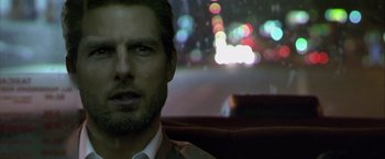 Movie still from “Collateral” (2004), directed by Michael Mann – A person in a car at night; Close Up shot, Over the shoulder angle